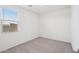 This bedroom features neutral carpet, natural light from the large window, and is pre-wired for ceiling fans at 18268 W La Senda Dr, Surprise, AZ 85387