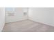 Carpeted bedroom with two windows provides plenty of natural light at 18268 W La Senda Dr, Surprise, AZ 85387
