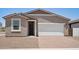 Cozy home featuring a low maintenance front yard, attached two car garage, and covered entryway at 18268 W La Senda Dr, Surprise, AZ 85387