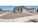 Well-kept single-story home featuring desert landscaping, a two-car garage, and sidewalks at 18268 W La Senda Dr, Surprise, AZ 85387