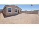The exterior of this home features a spacious, fenced backyard and pristine windows under a clear blue sky at 18268 W La Senda Dr, Surprise, AZ 85387