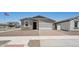 Charming single-story home featuring a low maintenance yard and brick paver driveway and neutral color palette at 18268 W La Senda Dr, Surprise, AZ 85387