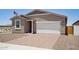 Inviting single-story home boasts an attached two-car garage, a paved driveway, and a low-maintenance yard at 18268 W La Senda Dr, Surprise, AZ 85387