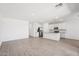 Open concept living area featuring a kitchen with white cabinets, a center island, and wood-look floors at 18268 W La Senda Dr, Surprise, AZ 85387