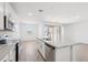 Modern kitchen with white cabinetry, stainless steel appliances, a center island, and a stylish backsplash at 18268 W La Senda Dr, Surprise, AZ 85387