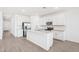 Beautiful kitchen boasts white cabinetry, stainless steel appliances, and a center island perfect for entertaining at 18268 W La Senda Dr, Surprise, AZ 85387