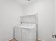 Bright laundry room features a new washer and dryer and plenty of additional shelving at 18268 W La Senda Dr, Surprise, AZ 85387
