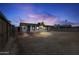 Wide shot of the spacious backyard and home at dusk at 2002 W Windrose Dr, Phoenix, AZ 85029