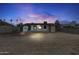 Wide shot of the spacious backyard and home at dusk, with beautiful cloudy sky at 2002 W Windrose Dr, Phoenix, AZ 85029