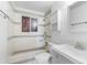 Cozy bathroom with white and gray tile, a medicine cabinet, and a shower at 2002 W Windrose Dr, Phoenix, AZ 85029