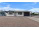 Charming single-story home with solar panels, a gravel yard, and a covered carport at 2002 W Windrose Dr, Phoenix, AZ 85029