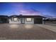 Charming single-story home with solar panels, a gravel front yard, and a modern black and white design at 2002 W Windrose Dr, Phoenix, AZ 85029