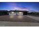Charming single-story home with solar panels, a gravel front yard, and a modern black and white design at 2002 W Windrose Dr, Phoenix, AZ 85029