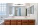 Bathroom features a double sink vanity with a large mirror and modern fixtures at 2024 W Darrel Rd, Phoenix, AZ 85041