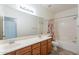 Neutral bathroom featuring double sinks, and a shower over tub at 2024 W Darrel Rd, Phoenix, AZ 85041