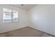 Bedroom with neutral carpet and walls, with a window for natural light at 2024 W Darrel Rd, Phoenix, AZ 85041