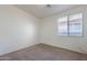 Bedroom with neutral carpet, walls, and a window to bring in natural light at 2024 W Darrel Rd, Phoenix, AZ 85041