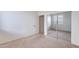 Bedroom with mirrored closet doors and neutral walls and carpet at 2024 W Darrel Rd, Phoenix, AZ 85041
