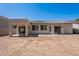 View of the back exterior with a covered patio, large sliding doors and potential for outdoor living at 2024 W Darrel Rd, Phoenix, AZ 85041