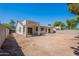 View of the back exterior with a covered patio, large sliding doors and potential for outdoor living at 2024 W Darrel Rd, Phoenix, AZ 85041