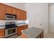 Traditional kitchen with stainless steel appliances, oak cabinets, and a center island at 2024 W Darrel Rd, Phoenix, AZ 85041