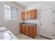 Functional laundry room with sink, storage cabinets, and access to outside at 2024 W Darrel Rd, Phoenix, AZ 85041