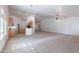 Large living area combines with a kitchen, complete with a ceiling fan, ideal for gatherings and daily living at 2024 W Darrel Rd, Phoenix, AZ 85041
