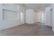 Neutral living room with new carpet, fresh paint, and a hallway with tiled floors at 2024 W Darrel Rd, Phoenix, AZ 85041