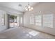 Bright living room with lots of light, neutral carpeting, and sliding door to outdoor patio at 2024 W Darrel Rd, Phoenix, AZ 85041