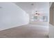Bright living room featuring carpet, a ceiling fan, and large windows for plenty of natural light at 2024 W Darrel Rd, Phoenix, AZ 85041