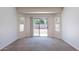 Bright living room featuring neutral walls and carpet with sliding door to the backyard at 2024 W Darrel Rd, Phoenix, AZ 85041