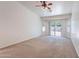 Bright living room featuring neutral walls and carpet with sliding door to the backyard at 2024 W Darrel Rd, Phoenix, AZ 85041