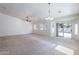 Expansive living area with neutral walls, a ceiling fan, and patio access for seamless indoor/outdoor living at 2024 W Darrel Rd, Phoenix, AZ 85041