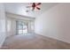 Bright living room featuring neutral walls and carpet with sliding door to the backyard at 2024 W Darrel Rd, Phoenix, AZ 85041