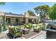 Expansive backyard featuring a covered patio, seating area, lush lawn, and a glimpse of the inviting pool at 2301 E Sunnyside Dr, Phoenix, AZ 85028