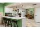Updated kitchen featuring white cabinets, a breakfast bar, stainless appliances, and a view of the backyard at 2301 E Sunnyside Dr, Phoenix, AZ 85028