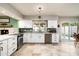 Bright kitchen area showcasing a range of appliances, white cabinetry, and access to the backyard at 2301 E Sunnyside Dr, Phoenix, AZ 85028
