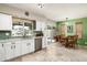 Bright kitchen with white cabinetry, modern appliances, and a view of the adjacent breakfast nook at 2301 E Sunnyside Dr, Phoenix, AZ 85028