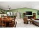 Open-concept living space with dining area, a green accent wall and tile flooring at 2301 E Sunnyside Dr, Phoenix, AZ 85028