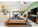 Open-concept living room with vaulted ceilings, travertine floors, and abundant natural light flowing from a large patio door at 2301 E Sunnyside Dr, Phoenix, AZ 85028