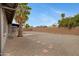 Large gravel backyard featuring desert landscaping, a block fence and a covered patio space at 3106 S Extension Rd, Mesa, AZ 85210