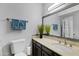 Bathroom with vanity, large mirror, and toilet at 3106 S Extension Rd, Mesa, AZ 85210