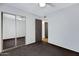 Bedroom with ceiling fan and large mirrored closet doors at 3106 S Extension Rd, Mesa, AZ 85210
