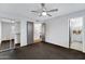 Bedroom featuring a ceiling fan, mirrored closet, and door to the bath at 3106 S Extension Rd, Mesa, AZ 85210