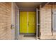 A vibrant yellow front door is protected by a silver security gate at 3106 S Extension Rd, Mesa, AZ 85210
