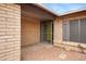 A close-up shot of the gated entry with a bright yellow door and neutral brick finishes at 3106 S Extension Rd, Mesa, AZ 85210