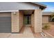 A charming home with a gated entrance and a gray garage door and brick finish at 3106 S Extension Rd, Mesa, AZ 85210