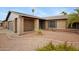 A home with brick finishes, desert landscaping and a charming gated entrance at 3106 S Extension Rd, Mesa, AZ 85210