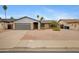 Charming brick home with desert landscaping and mature palm trees on a sunny day at 3106 S Extension Rd, Mesa, AZ 85210