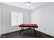 Game room with portable pool table, ceiling fan, window, and neutral carpet at 3106 S Extension Rd, Mesa, AZ 85210